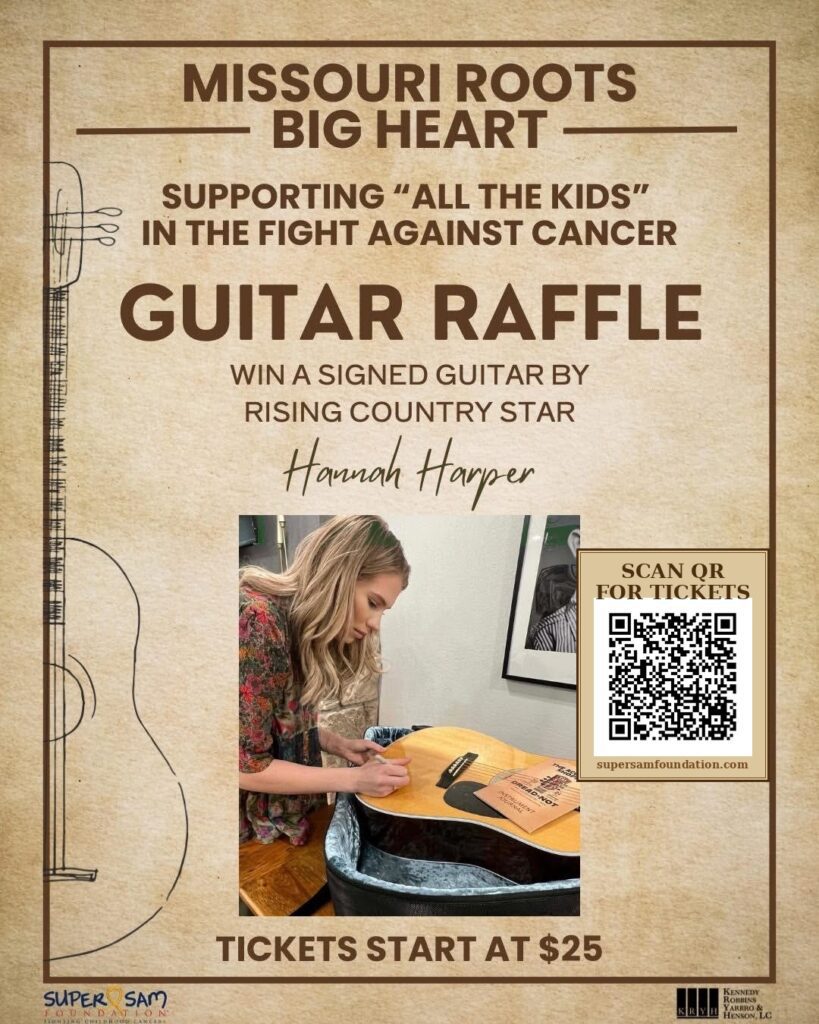 Hannah Harper signs guitar for Super Sam Foundation Raffle